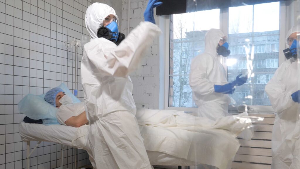 Doctors in protective suits dancing in a hospital chamber